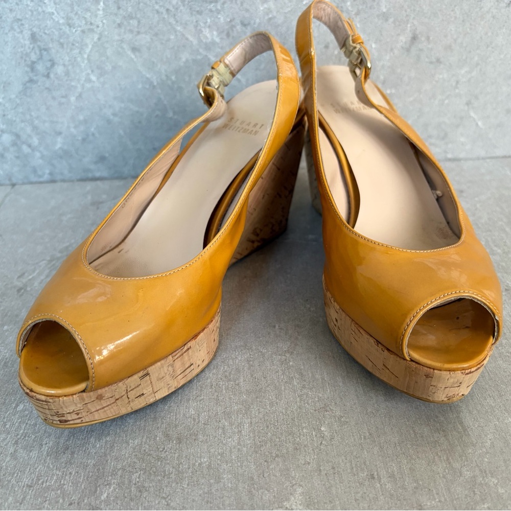 Tan patent-leather peep-toe wedges